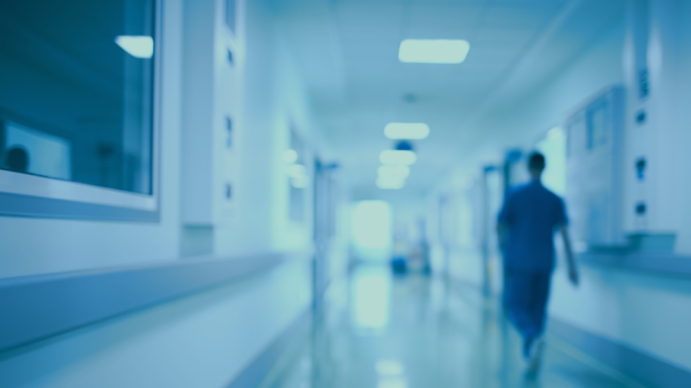 A hospital scene blured a nurse walking on the right